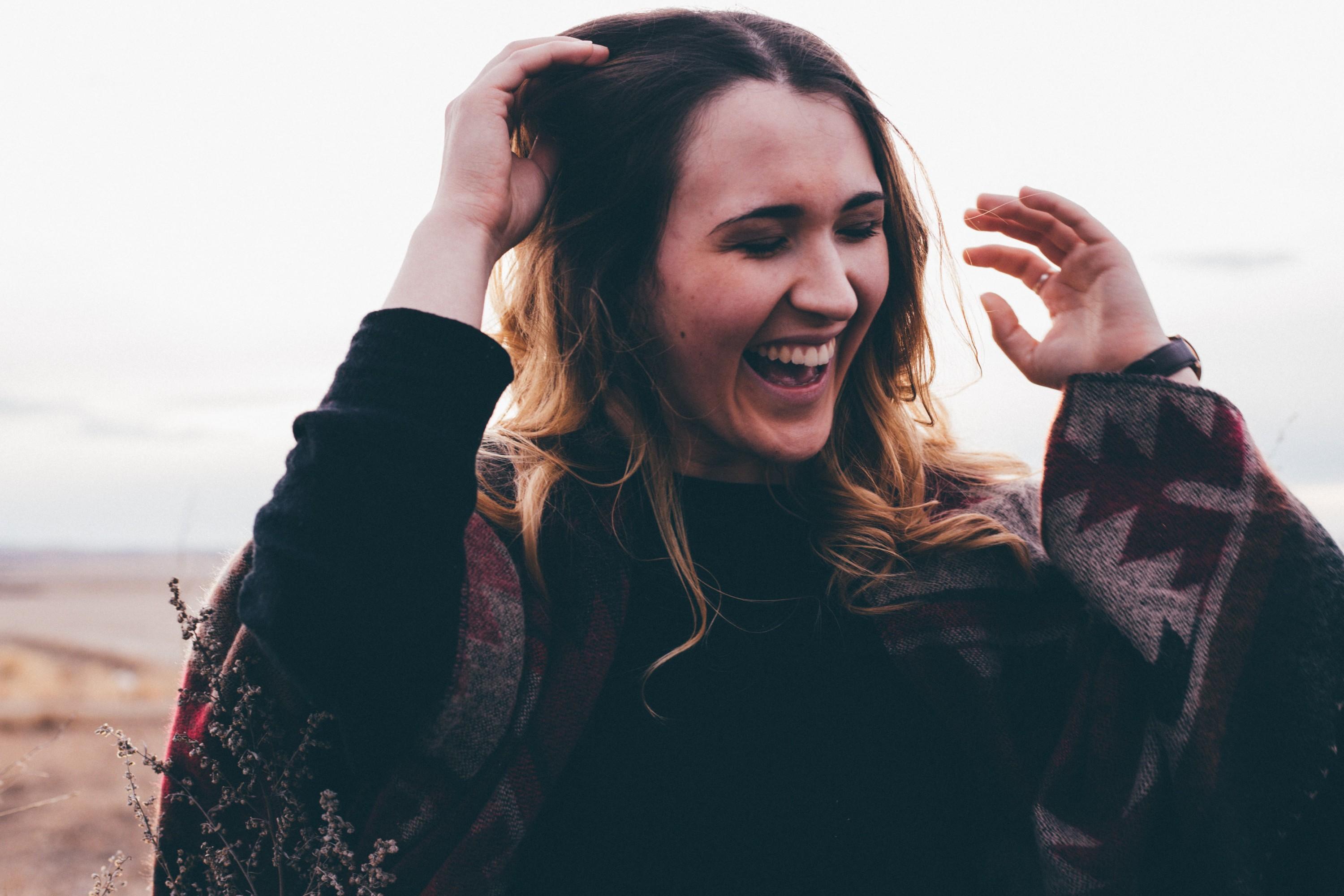 woman smiling after investing in a kiwisaver return fund